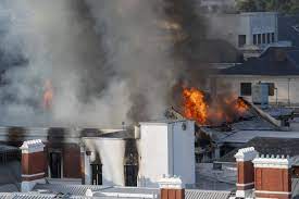 South African police charge a man with arson as the parliament was totally gutted by fire.