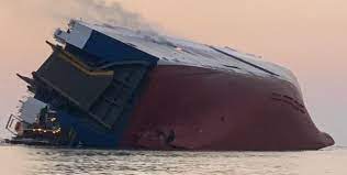 In the mid-Atlantic, a massive cargo ship transporting vehicles sinks.
