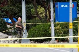 A shootout at a Canadian bank resulted in the death of two armed men and injury to six officers.